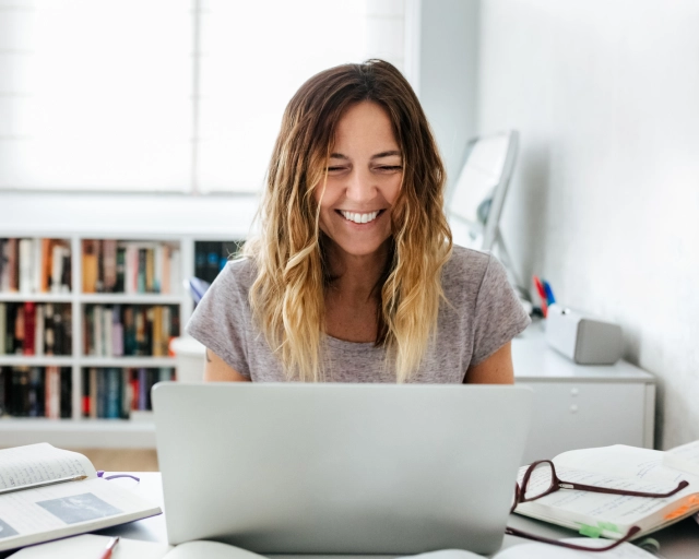 smiling woman on computer